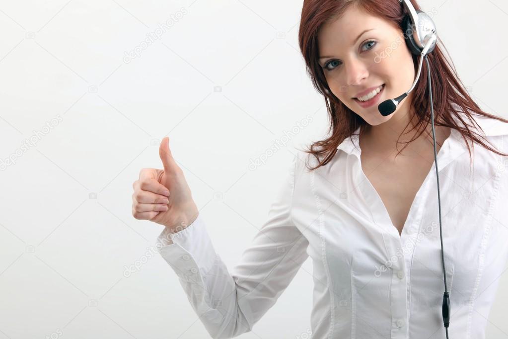 Girl talking on headphones and shows the sign