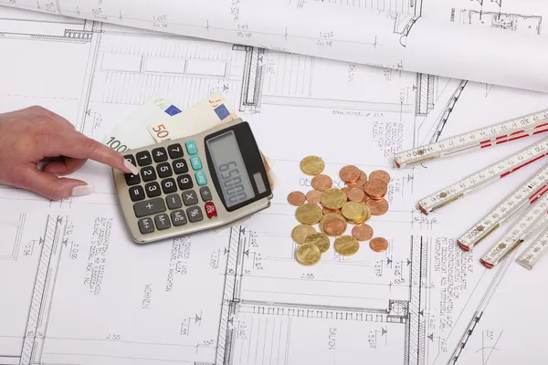 Hands with house construction plan, calculator, money, coins — Stock Photo, Image