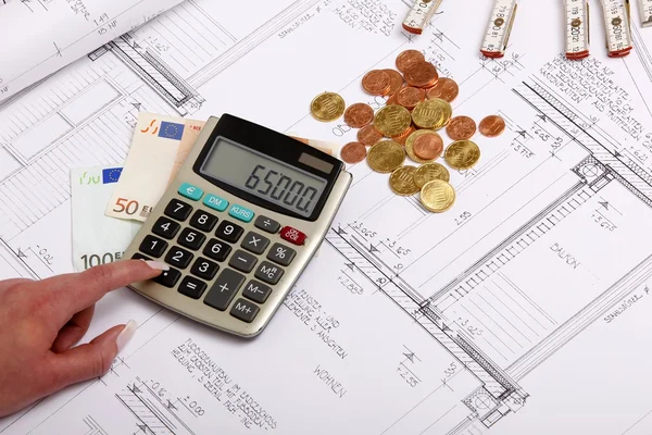 Hands with house construction plan, calculator, money, coins — Stock Photo, Image