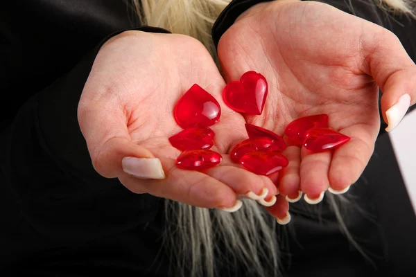 Manos llenas de pequeños corazones — Foto de Stock