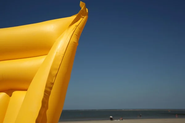 Yellow air mattress on the beach — Stock Photo, Image