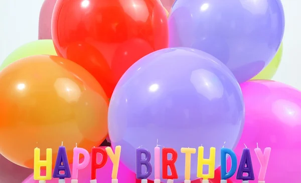 Happy birthday candles and balloons — Stock Photo, Image