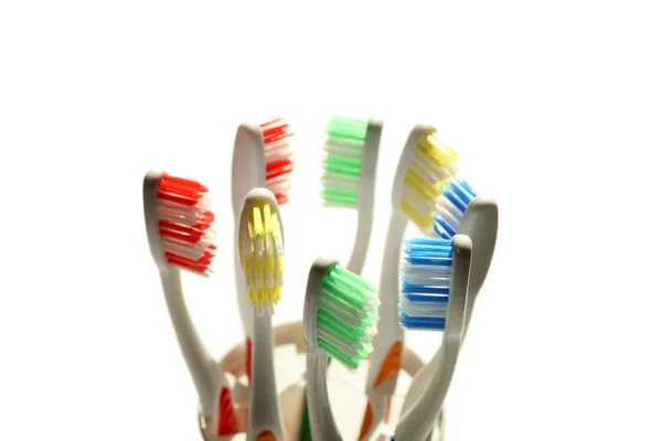 Bir su bardağına çok renkli diş fırçaları — Stok fotoğraf