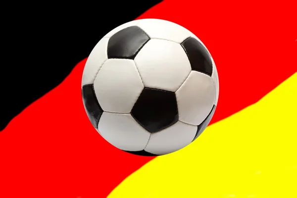 Fußball auf einer deutschen Fahne — Stockfoto