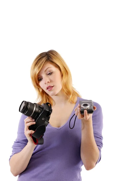 Ela detém câmera reflexa de lente única e câmera compacta — Fotografia de Stock
