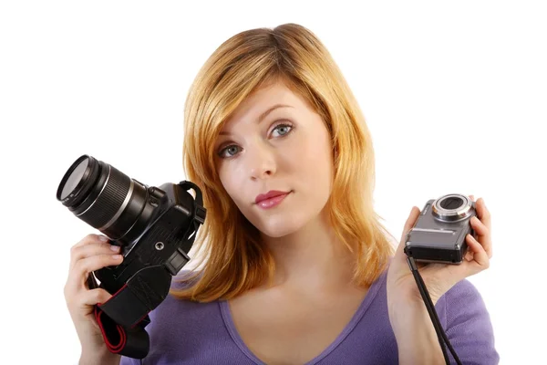 Ela detém câmera reflexa de lente única e câmera compacta — Fotografia de Stock