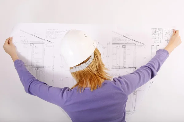 Woman with helmet and blueprint — Stock Photo, Image
