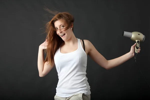 Young beauty with hairdryer Stock Photo
