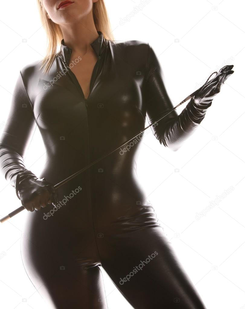 Sexy girl in latex suit with a whip