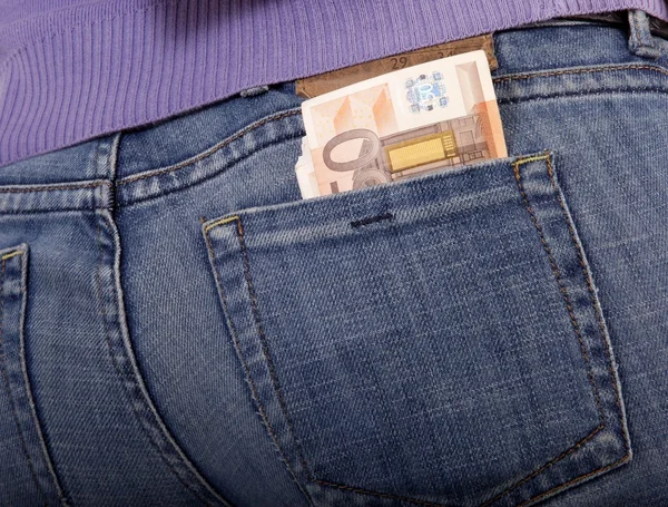 Woman with bank notes in jeans (white background) — Stock Photo, Image