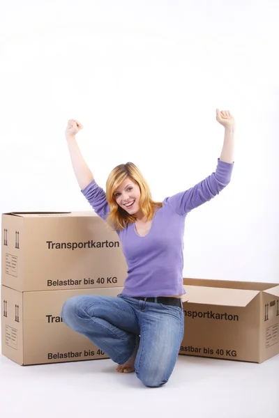 Happy girl near boxes — Stock Photo, Image