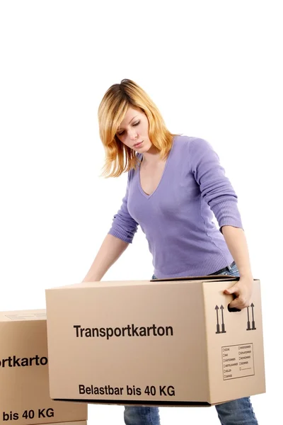Young woman with moving boxes (white background) — Stock Photo, Image