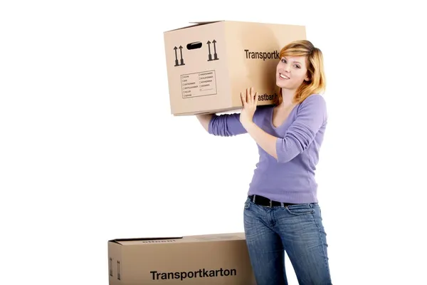 Young woman with moving boxes (white background) — Stock Photo, Image