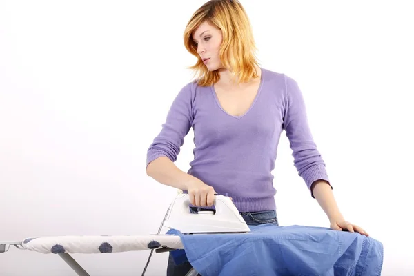 Beautiful young woman ironing (white background) — Stock Photo, Image