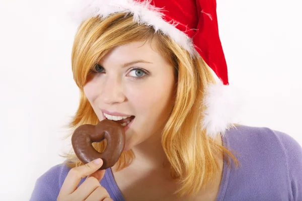 Young woman with santa hat and gingerbread (white background) — Stock Photo, Image