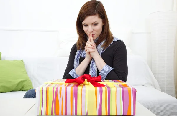 Young woman with a packed gift — Stock Photo, Image