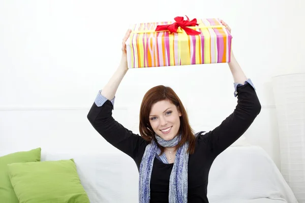 Young woman with a packed gift — Stock Photo, Image