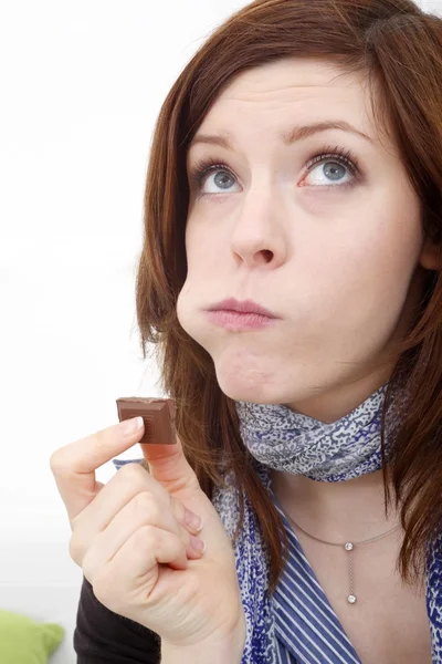 Young beautiful woman with a bar of chocolate — Stock Photo, Image