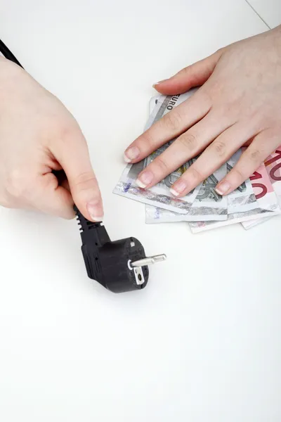 Hands with plug and money — Stock Photo, Image