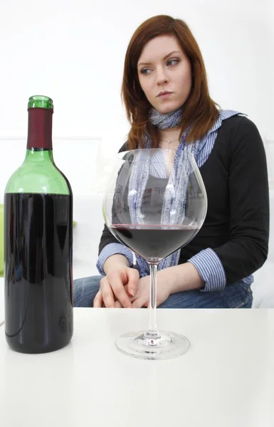 Woman with a bottle of wine and a wineglass — Stock Photo, Image