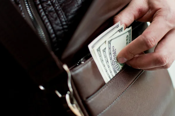 100 dollar bills and a leather bag — Stock Photo, Image