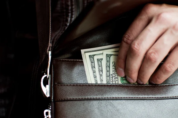 100 dollar bills and a leather bag — Stock Photo, Image