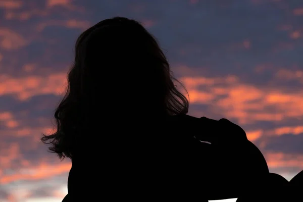 silhouette of beautiful blonde woman at sunset
