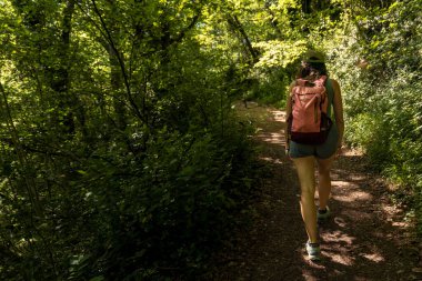 Bask ülkesinin ormanlarında şortlu bir kadın yürüyor.