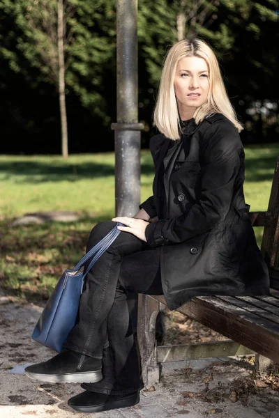 Pensive Blonde Woman Black Dress Sitting Park — Stock Photo, Image