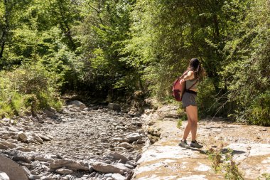 joyful woman in the bush spinning around