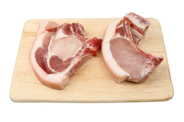 Pork chops on a board — Stock Photo, Image