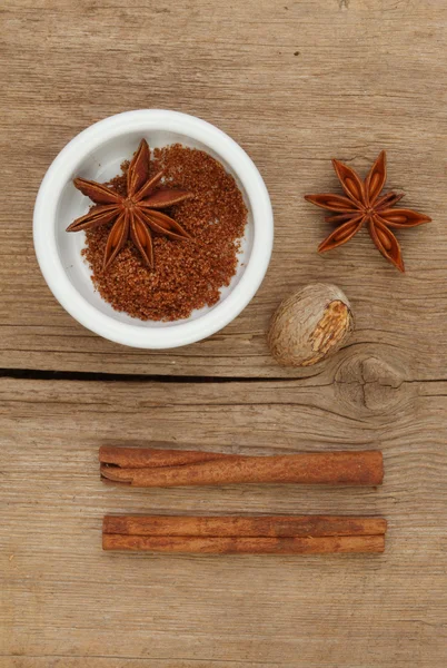 Spices and ramekin on wood — Stock Photo, Image