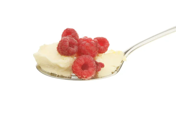 Raspberries and cream in a spoon — Stock Photo, Image