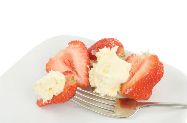 Strawberries cream and a fork on a plate — Stock Photo, Image