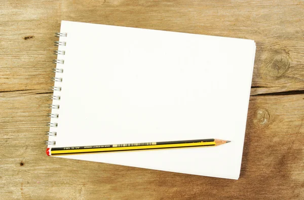 Sketch pad and pencil on wood — Stock Photo, Image