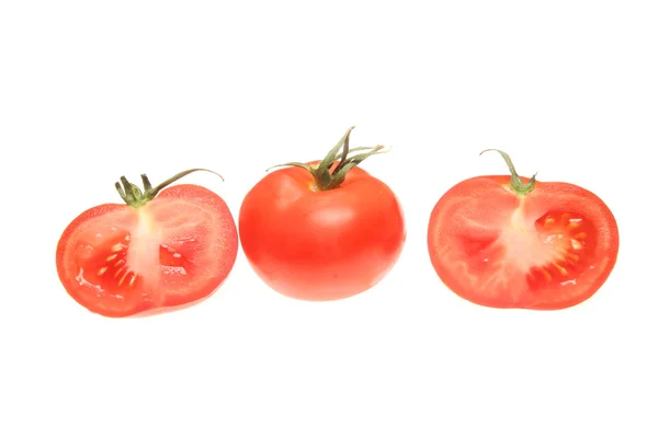 Cut and whole tomatoes — Stock Photo, Image