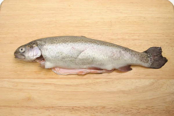 Fresh rainbow trout on a wooden board — Stock Photo, Image