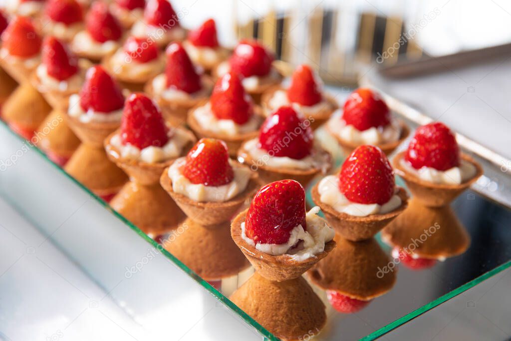 Mini Strawberry Fruit appetizing Tarts. Pastry cupcake dessert with strawberry fruits and cream