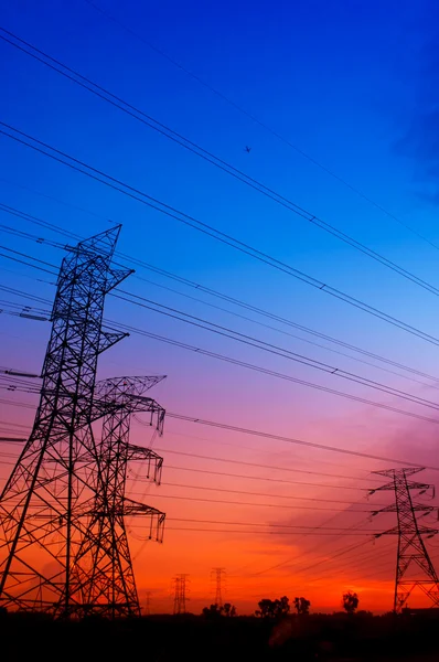 Silhouette electricity pylons — Stock Photo, Image