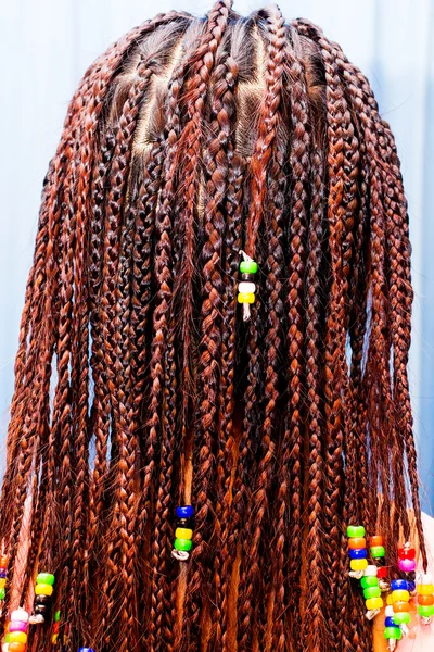 Hair braiding with colorful beads — Stock Photo, Image