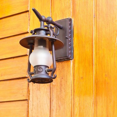 ahşap duvarda asılı eski moda lamba