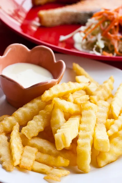 Patatine fritte e maionese su piatto bianco con bistecca e insalata — Foto Stock