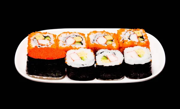 Sushi i vit platta på svart bakgrund — Stockfoto