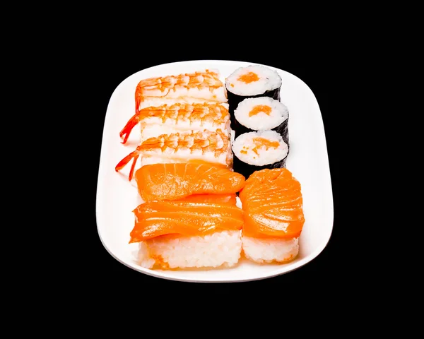 Sushi i vit platta på svart bakgrund — Stockfoto