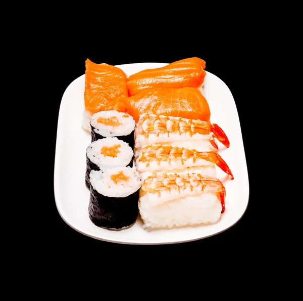 Sushi i vit platta på svart bakgrund — Stockfoto