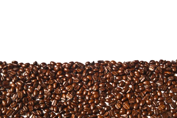 Många bruna kaffebönor för bakgrund — Stockfoto