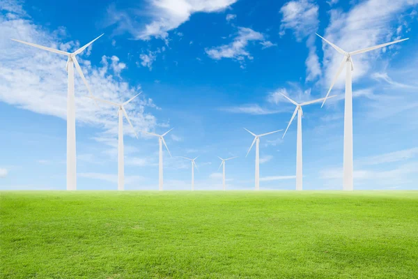 Wind turbine on green grass with blue sky — Stock Photo, Image