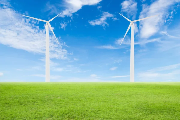 Wind turbine on green grass with blue sky — Stock Photo, Image