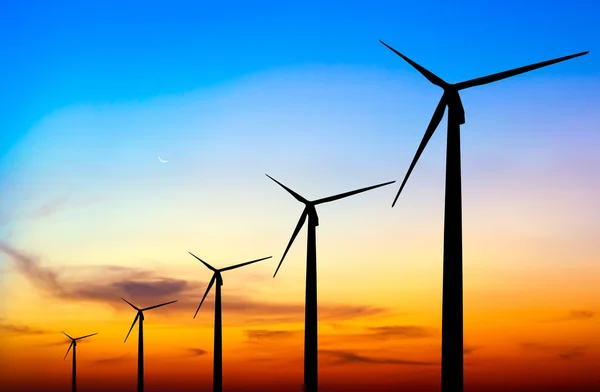 Wind turbine silhouette on colorful sunset — Stock Photo, Image