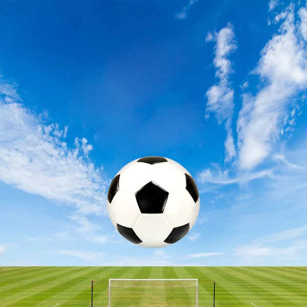 Soccer ball with soccer field against  blue sky background — Stock Photo, Image